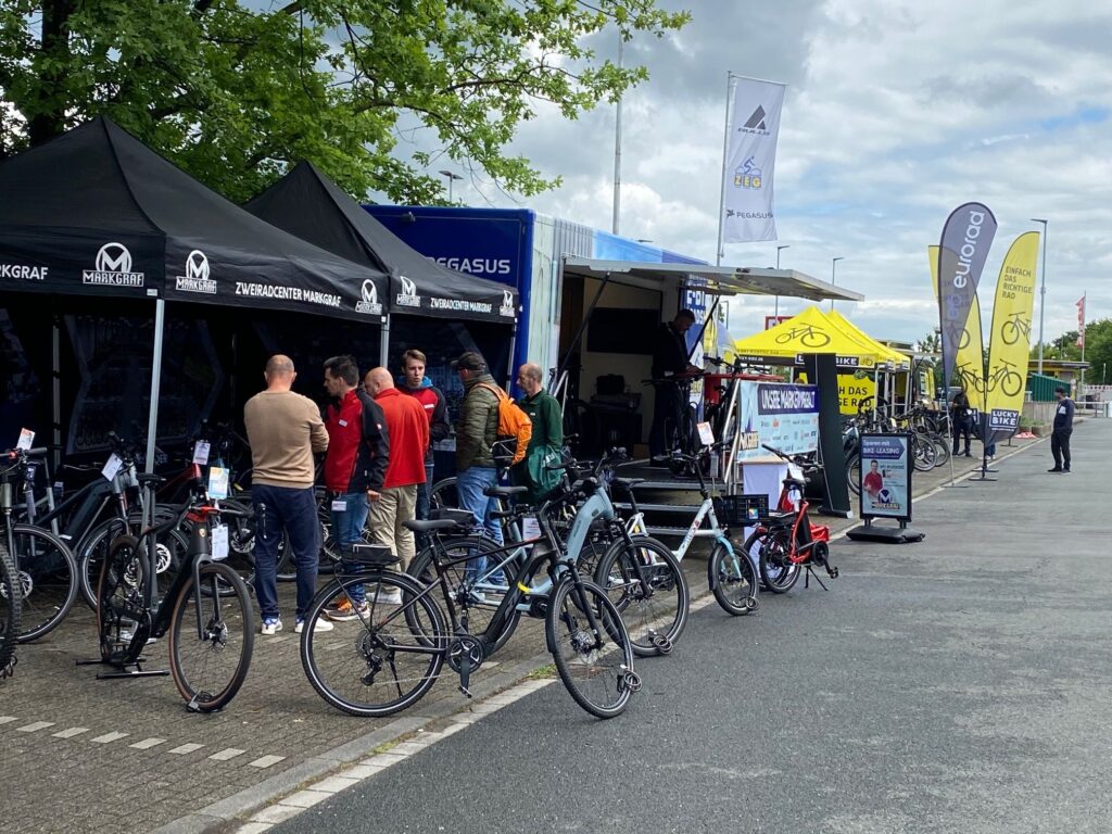 A gathering of cyclists at a festival or other outdoor event.